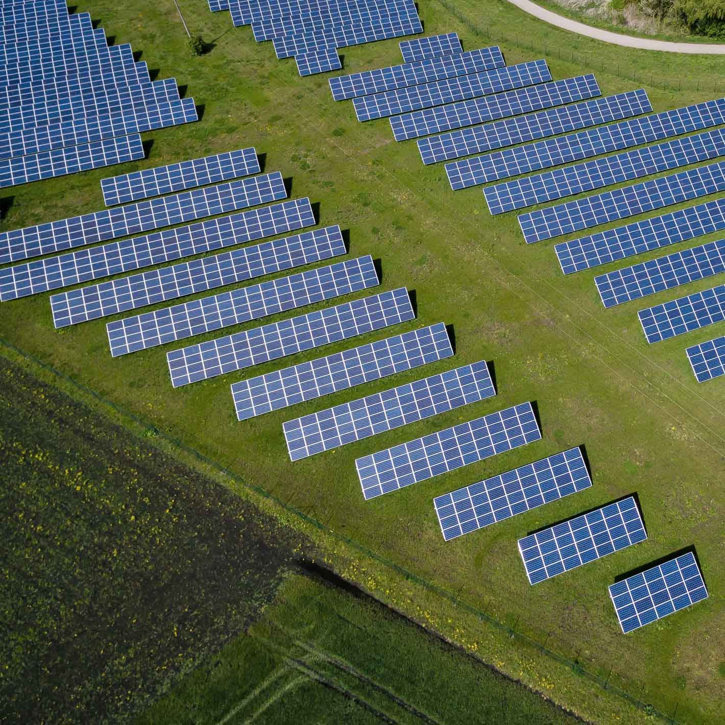Aerial image of a solar array in a green field.
