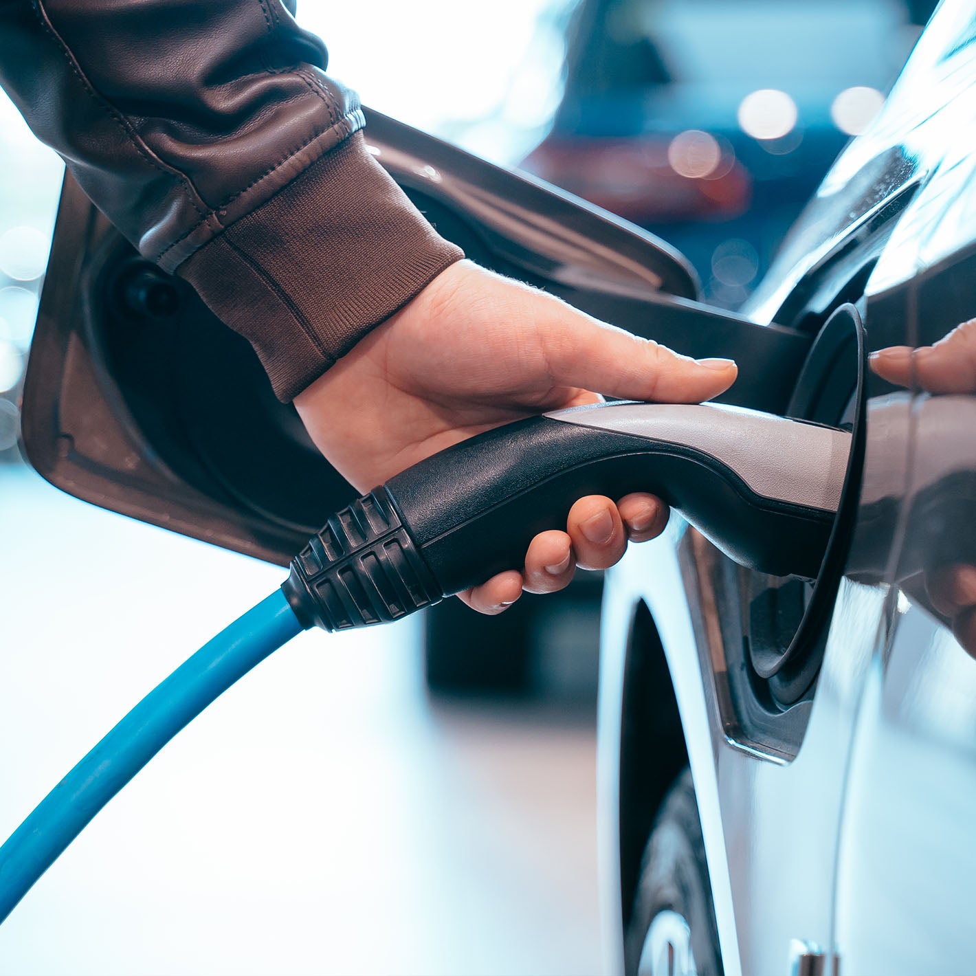 hand holding charging unit in side of car