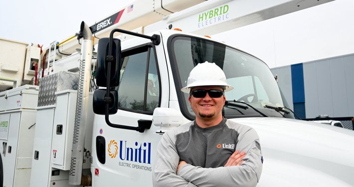 Lineworker Dakota Hunter infront of Unitil truck