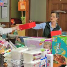 Two Unitil employees making care packages. 