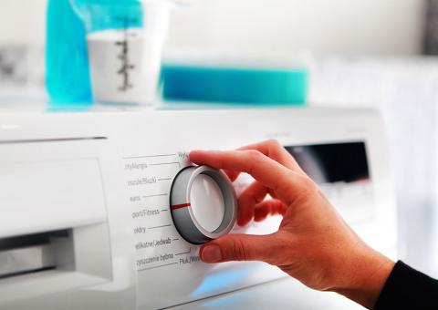 hand on dial of energy star washing machine