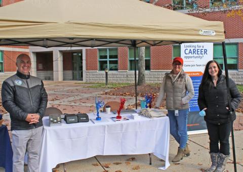 Unitil employees stand at career fair tent