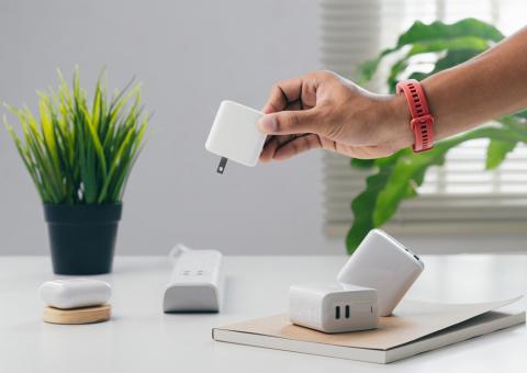 person removing plug from power strip